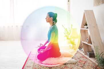 Image showing woman meditating in lotus pose at yoga studio