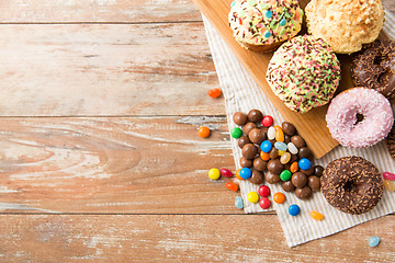 Image showing close up of glazed donuts, candies and cupcakes