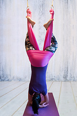 Image showing Young woman making antigravity yoga exercises
