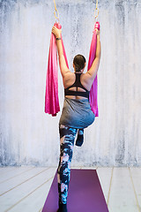 Image showing Young woman making antigravity yoga exercises