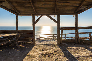 Image showing A conversation of wooden beam, on the beach, sunset