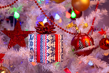 Image showing Beautiful small gift on the Christmas tree branch