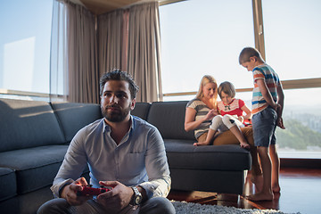 Image showing Happy family playing a video game