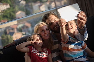 Image showing happy young couple spending time with kids at home