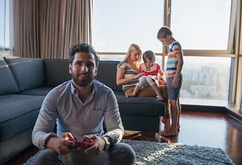 Image showing Happy family playing a video game