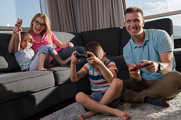 Image showing Happy family playing a video game