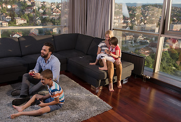 Image showing Happy family playing a video game