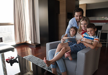 Image showing happy young couple spending time with kids