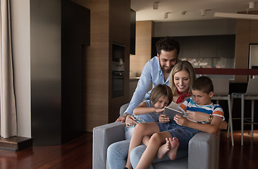 Image showing happy young couple spending time with kids