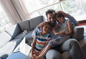 Image showing happy young father spending time with kids