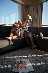 Image showing happy young couple spending time with kids at home