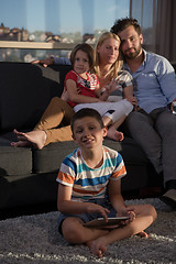 Image showing happy young couple spending time with kids at home