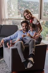 Image showing happy young couple spending time with kids