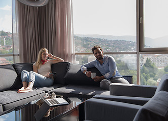 Image showing couple relaxing at  home using tablet computer