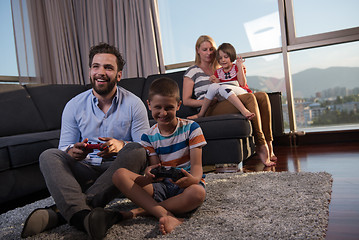 Image showing Happy family playing a video game