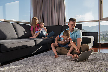 Image showing Happy family playing a video game