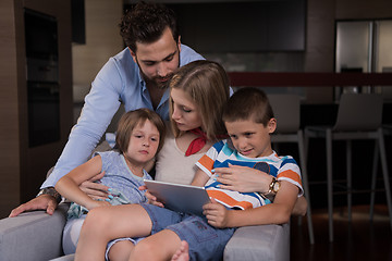 Image showing happy young couple spending time with kids