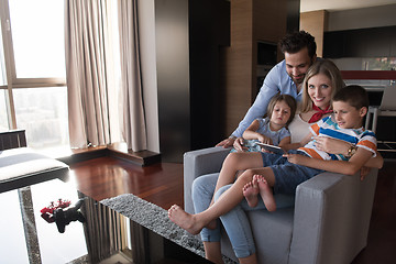 Image showing happy young couple spending time with kids