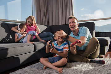 Image showing Happy family playing a video game