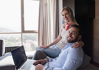 Image showing couple relaxing at  home using laptop computers