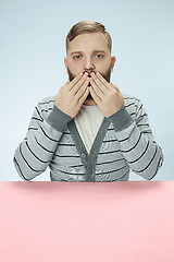 Image showing Young man covering mouth by hands