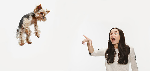 Image showing Woman with her dog on leash over white background