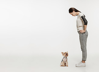 Image showing Woman with her dog on leash over white background