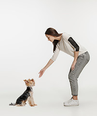 Image showing Woman with her dog on leash over white background