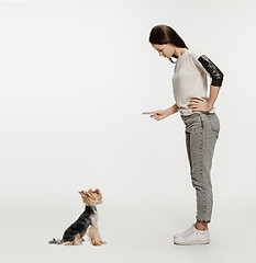 Image showing Woman with her dog on leash over white background