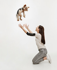 Image showing Woman with her dog on leash over white background