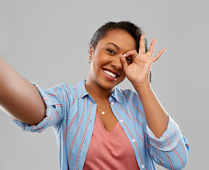 Image showing happy african american woman taking selfie