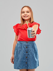 Image showing smiling preteen girl drinking soda from can