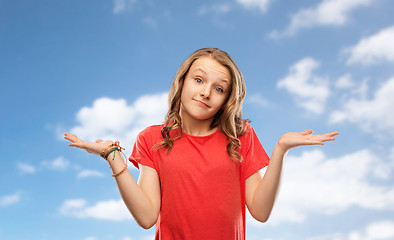 Image showing wondering teenage girl in red t-shirt shrugging