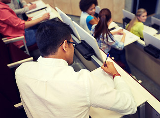 Image showing group of students with notebooks in lecture hall