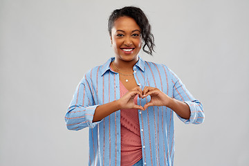 Image showing african american woman making hand heart gesture