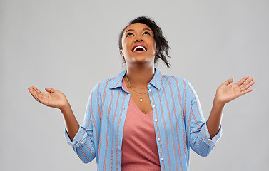 Image showing grateful african american woman looking up