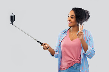 Image showing african american woman taking selfie by smartphone