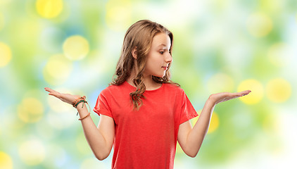 Image showing smiling teenage girl holding empty hand