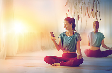 Image showing woman with smartphone at yoga studio