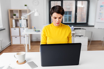 Image showing businesswoman with laptop working at office