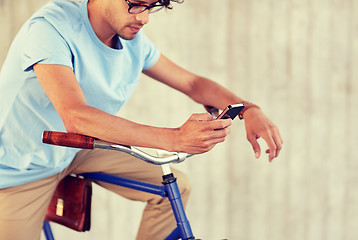 Image showing man with smartphone and fixed gear bike on street