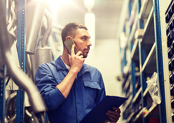 Image showing auto mechanic with clipboard at car workshop