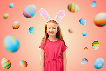 Image showing happy red haired girl wearing easter bunny ears