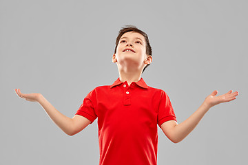 Image showing happy grateful boy in red t-shirt looking up