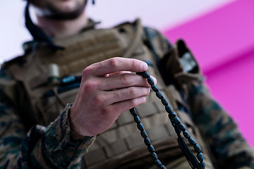 Image showing soldier praying tespih