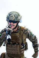 Image showing soldier in action aiming laseer sight optics