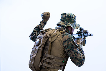 Image showing soldier in action giving comands to team by hand sign