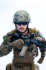 Image showing soldier in action aiming laseer sight optics