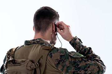 Image showing soldier preparing gear for action and checking communication