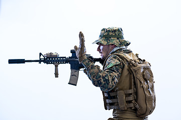 Image showing soldier in action aiming laseer sight optics